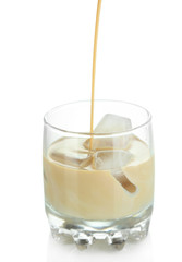 Pouring liquor in glass isolated on white