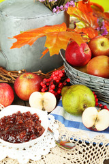 Juicy apples in basket on table close-up