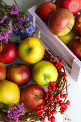 Juicy apples in box on white wooden table