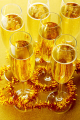 Glasses with champagne on shiny background