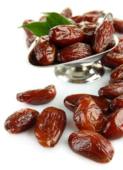 Dried dates in metal dish isolated on white
