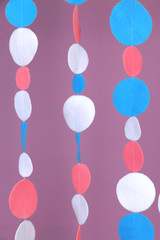 Decorative felt garland on violet background