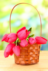 Fototapeta na wymiar Bouquet of beautiful artificial flowers basket, on wooden table