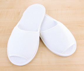 White slippers on wooden background