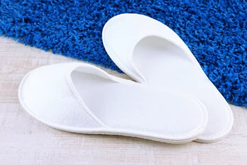 Türaufkleber White slippers on floor background © Africa Studio