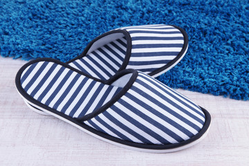 Striped slippers on floor background