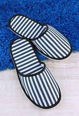 Striped slippers on floor background