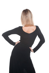 Trendy blonde woman in black dress standing back