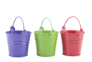 Three buckets of different colors, isolated on white background.