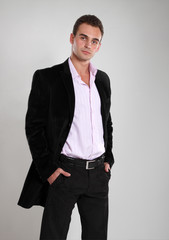 Trendy man in black pink and black jacket, portrait of sexy fash