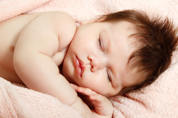 Fototapeta na wymiar cute infant baby sleeping, beautiful kid's face closeup