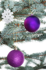 Christmas balls handing on a tree.