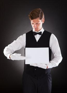 Young Waiter Holding Blank Placard