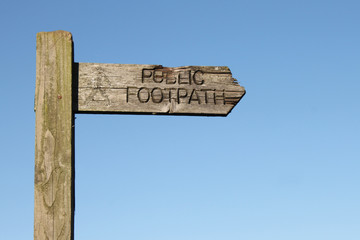Weathered wooden footpath sign