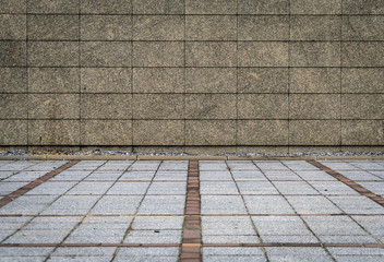 Granite tiles wall and concrete block pavement