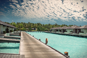 houses on piles on sea. Maldives.,with a retro effect