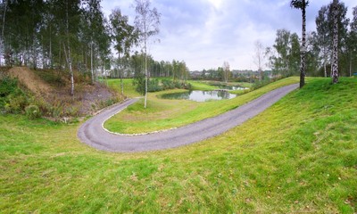 Golf course landscape view with road