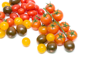 different cherry tomatoes on a white background