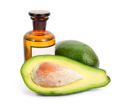 Avocado with pharmaceutical bottle isolated on white background.