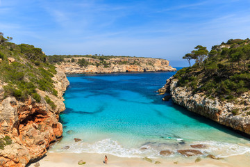 Fototapeta premium Unidentified young woman on beach, Cala des Moro, Majorca