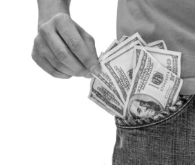 human hand is putting money in the pocket  Isolated on white bac