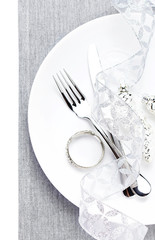 Christmas table place setting with christmas decorations  in whi