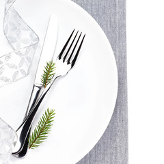 Christmas table place setting with christmas decorations in whi
