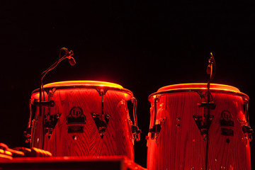 Steel drums illuminated on a stage