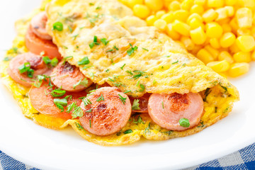 Omelet with sausage, tomato and herbs