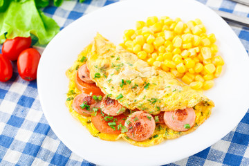 Omelet with sausage, tomato and herbs
