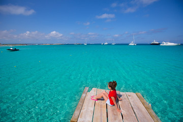 Kid girl looking at tropical Mediterranean sea from wood pier