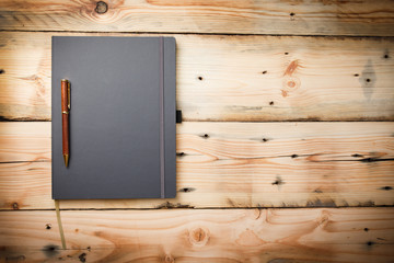 Leather cover note book on wooden background