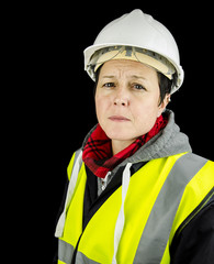 female builder unhappy wearing vest and safety helmet