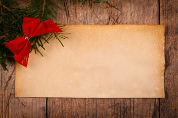 Wooden background with Christmas ornaments and old paper