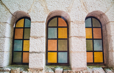 Colored Arched Windows in Plaster Building