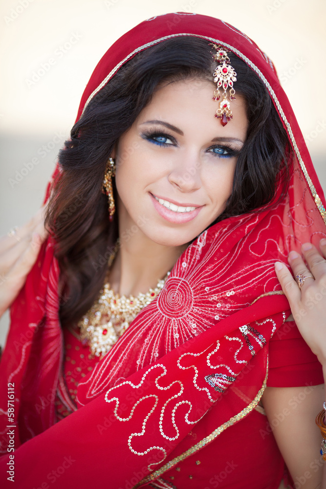 Wall mural beautiful indian woman bride in red dress