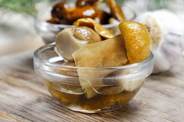Pickled mushrooms in transparent glass bowl