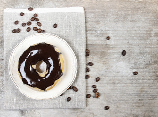 Delicious donut with chocolate on wooden table. Top view