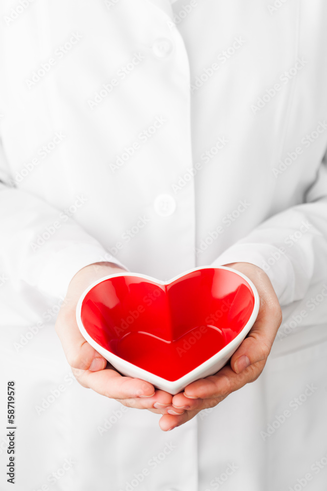 Fototapete red heart shape in hands