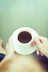 hands holding a cup of coffee