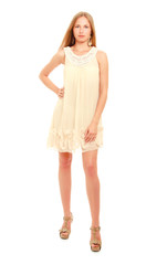 Cute young blonde woman posing in stylish dress.