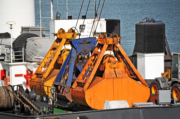Rusty scoop of cargo crane on the ship deck