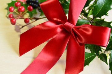 red ribbon with holly leaves