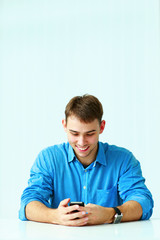 Young smiling casual businessman sitting 