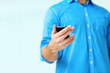 Closeup image af a man holding smartphone
