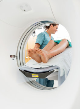 Nurse Looking At Patient Undergoing CT Scan