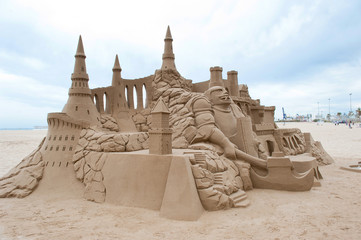 Grand sandcastle on the beach during a summer day.