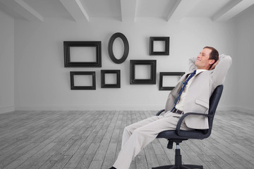 Composite image of side view of businessman leaning back in his