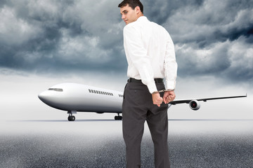 Composite image of businessman wearing handcuffs