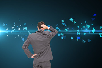 Composite image of young businessman standing back to camera scr